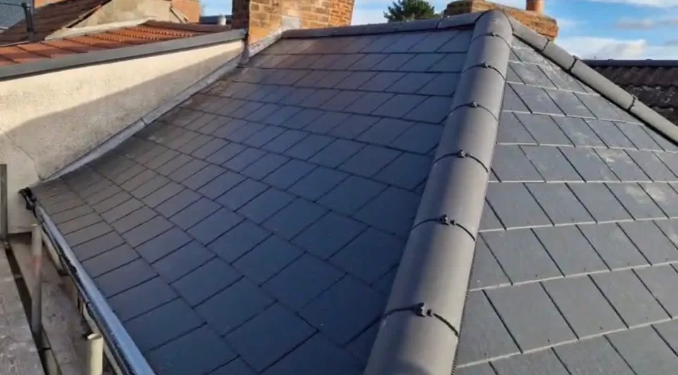 A finished dark slate roof with a new hip ridge, completed by J&nbsp;O&nbsp;B Done Roofing